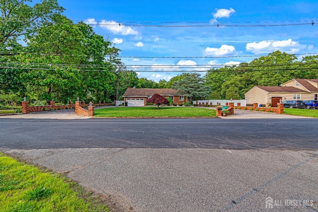34 Brookside Ave, Old Bridge, NJ 08857 - view of front of house featuring a front yard and asphalt driveway