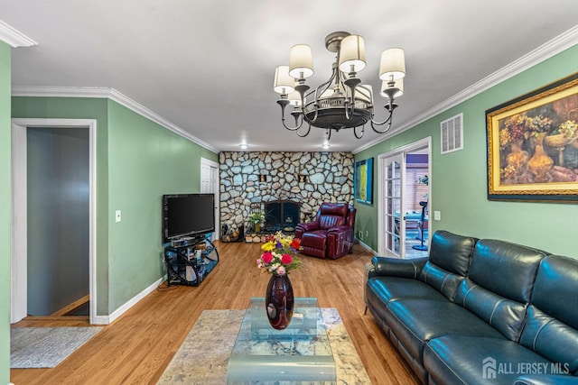34 Brookside Ave, Old Bridge, NJ 08857 - living area featuring wood finished floors, baseboards, ornamental molding, a chandelier, and a stone fireplace