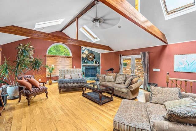 34 Brookside Ave, Old Bridge, NJ 08857 - living room featuring a skylight, beamed ceiling, wood-type flooring, ceiling fan, and a glass covered fireplace