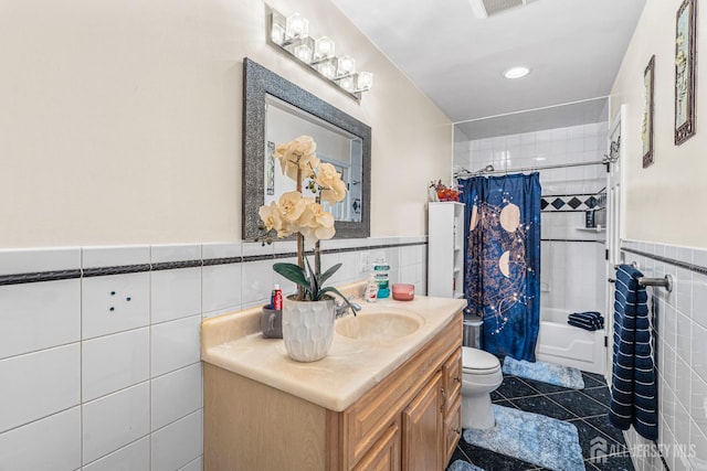 34 Brookside Ave, Old Bridge, NJ 08857 - bathroom with tile walls, a wainscoted wall, toilet, vanity, and shower / tub combo