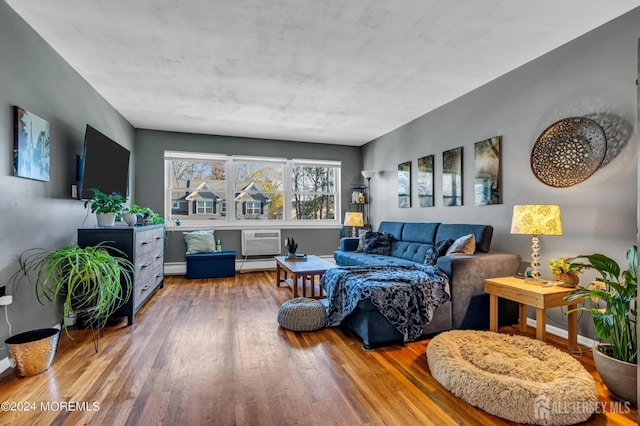 32 Woodedge Ave Unit 5, Edison, NJ 08817 - living area featuring wood finished floors, an AC wall unit, a baseboard radiator, baseboard heating, and baseboards