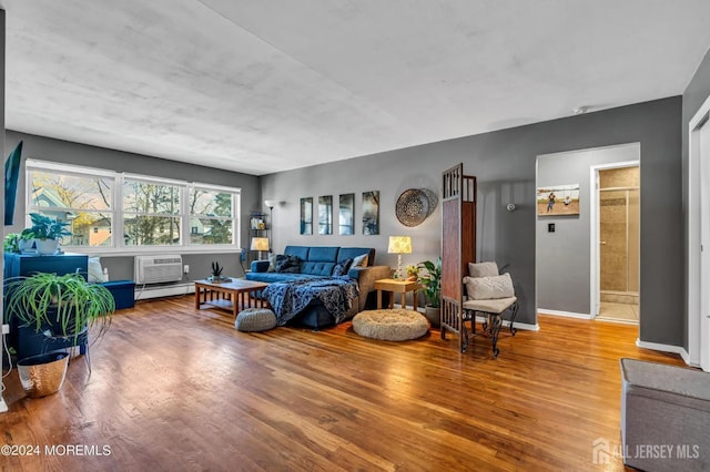 32 Woodedge Ave Unit 5, Edison, NJ 08817 - living area with wood finished floors, a baseboard radiator, baseboards, and an AC wall unit