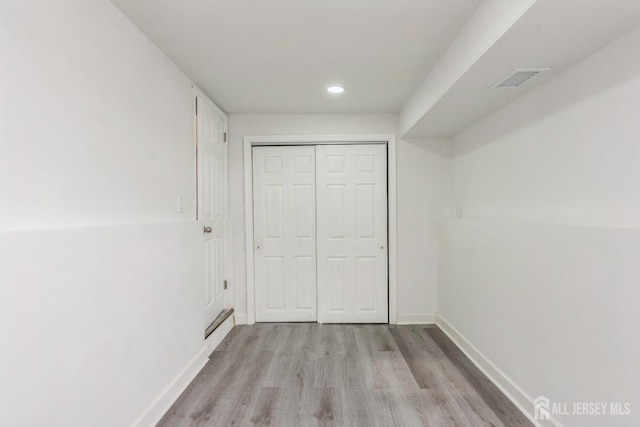 interior space with a closet and light hardwood / wood-style flooring