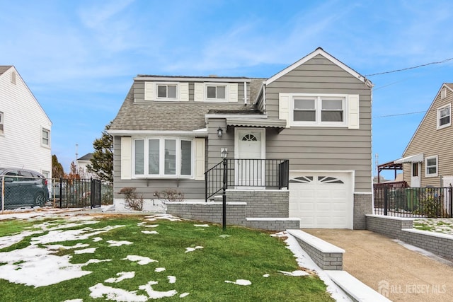 view of front facade with a garage and a front yard