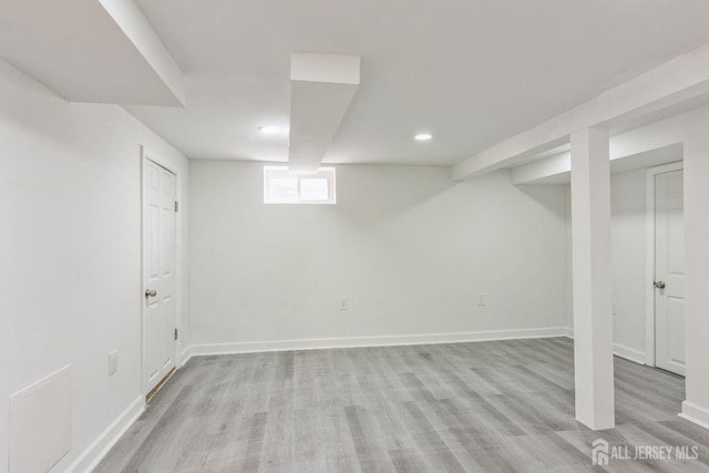 basement with light hardwood / wood-style floors