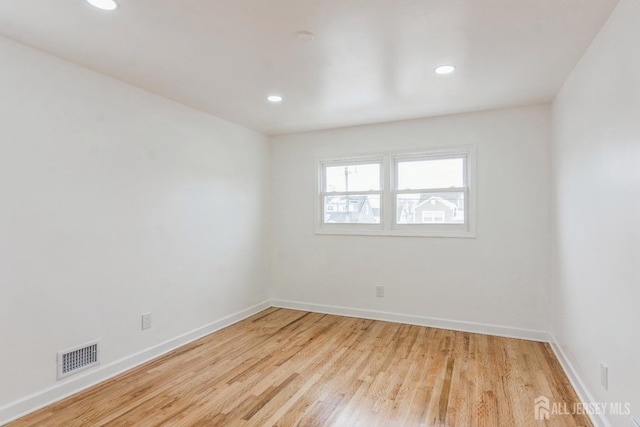 spare room with light hardwood / wood-style flooring