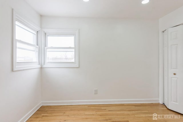 spare room featuring light hardwood / wood-style flooring