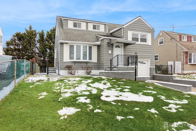 split level home featuring an attached garage, a shingled roof, a front yard, and fence