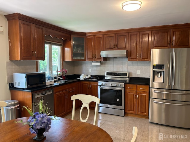 6 Quaker St, Edison, NJ 08820 - kitchen with stainless steel appliances, under cabinet range hood, granite floors, dark countertops, and glass insert cabinets