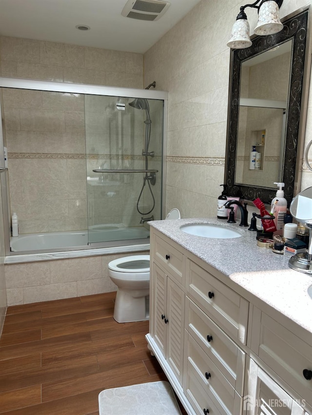 6 Quaker St, Edison, NJ 08820 - bathroom with tiled shower / bath combo, vanity, wood finished floors, and tile walls