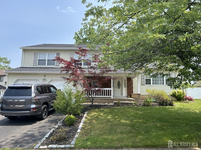 6 Quaker St, Edison, NJ 08820 - view of front of house featuring driveway, covered porch, a front yard, and an attached garage