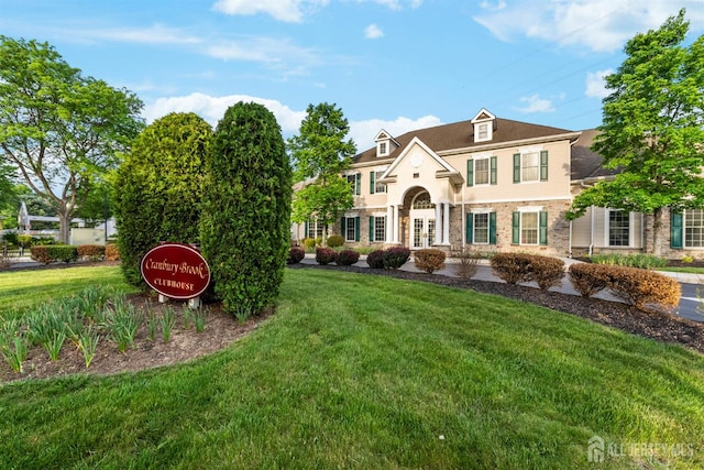 view of front of home featuring a front lawn and french doors