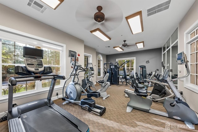 exercise room with a ceiling fan, carpet flooring, and baseboards
