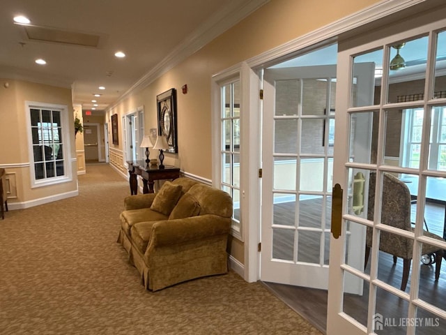 entryway with ornamental molding, carpet, and recessed lighting