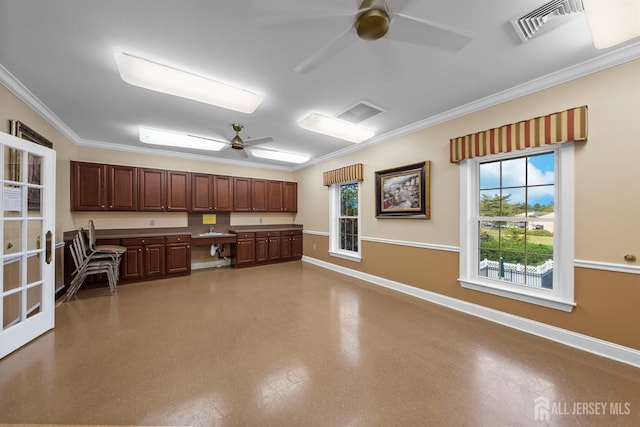 kitchen with ceiling fan, ornamental molding, baseboards, and a sink