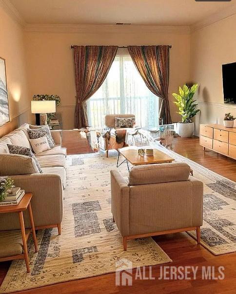 100 Middlesex Blvd Unit 321, Plainsboro, NJ 08536 - living area featuring healthy amount of natural light, wood finished floors, and ornamental molding