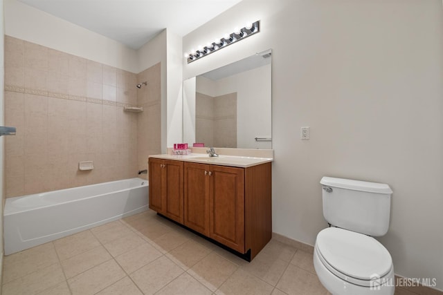 bathroom featuring tile patterned floors, bathing tub / shower combination, toilet, and vanity