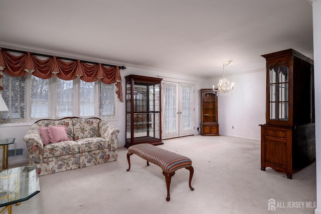 carpeted living room featuring a chandelier and crown molding