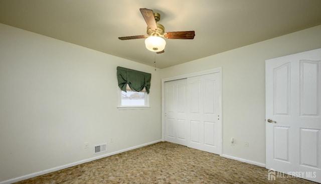 unfurnished bedroom with ceiling fan, a closet, and carpet flooring