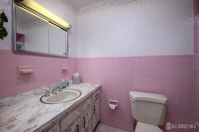 bathroom featuring toilet and vanity