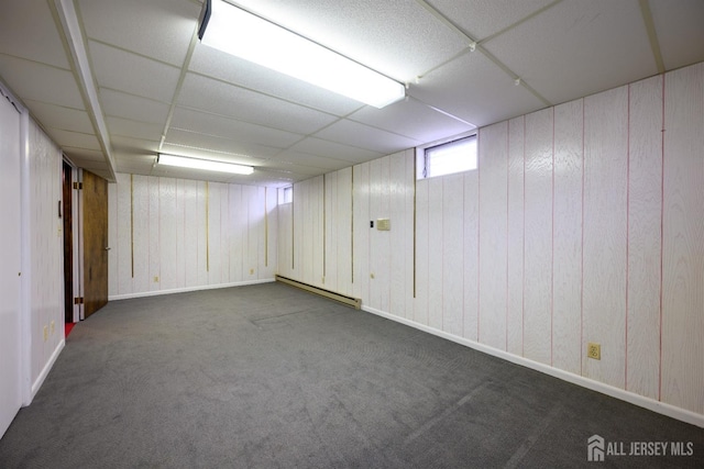 basement featuring a baseboard radiator, carpet, and a paneled ceiling