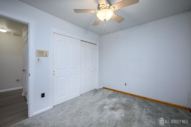 unfurnished bedroom featuring ceiling fan, carpet, and a closet