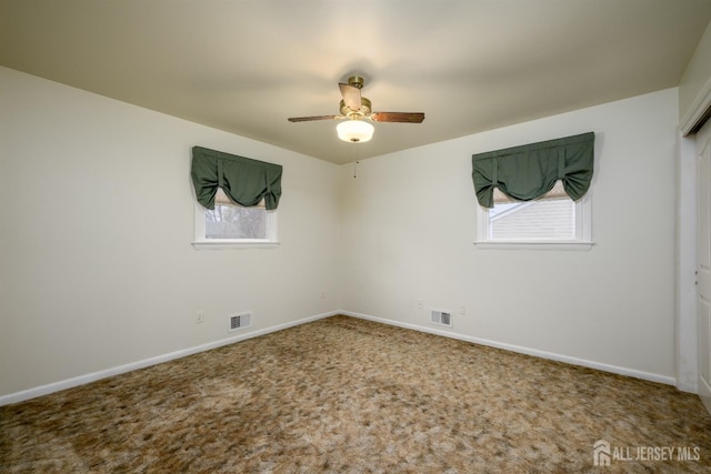 carpeted empty room featuring ceiling fan