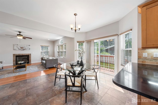 841 Harrell Ave, Woodbridge Proper, NJ 07095 - dining area featuring a glass covered fireplace, a ceiling fan, wood finished floors, and a chandelier