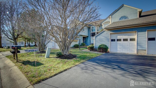 view of front of house with a garage and a front yard