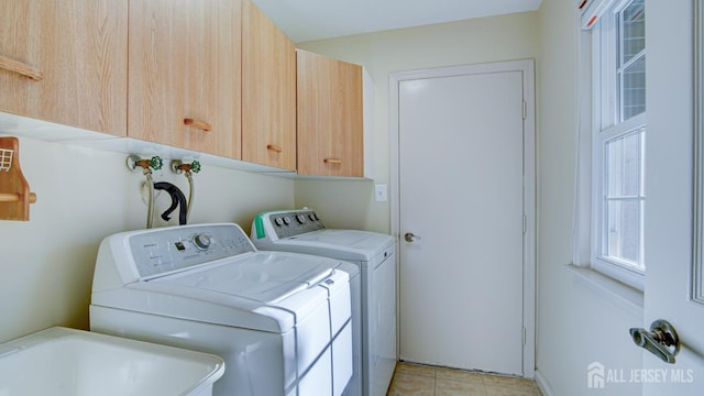 laundry area featuring cabinets, sink, washer and dryer, and light tile patterned floors