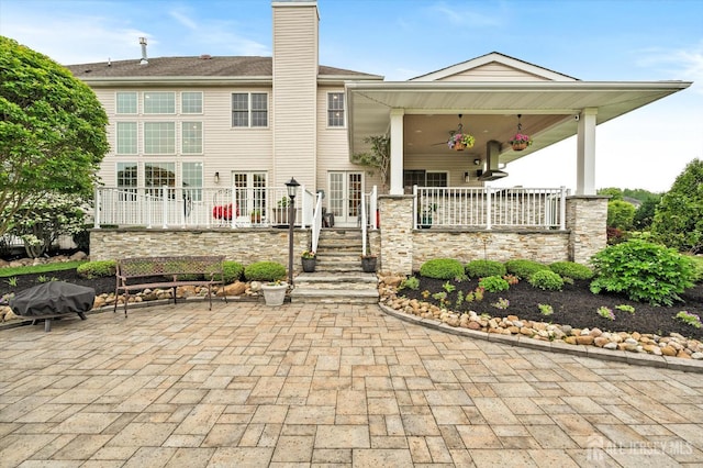 9 Bouvier Ln, South Brunswick, NJ 08816 - back of property featuring a chimney and a patio