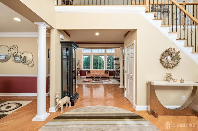 9 Bouvier Ln, South Brunswick, NJ 08816 - foyer featuring ornate columns, wood finished floors, baseboards, crown molding, and stairway