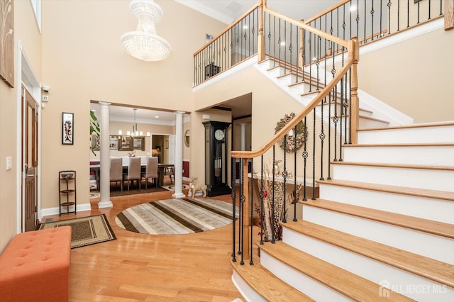 9 Bouvier Ln, South Brunswick, NJ 08816 - entryway with decorative columns, a high ceiling, a chandelier, crown molding, and stairway