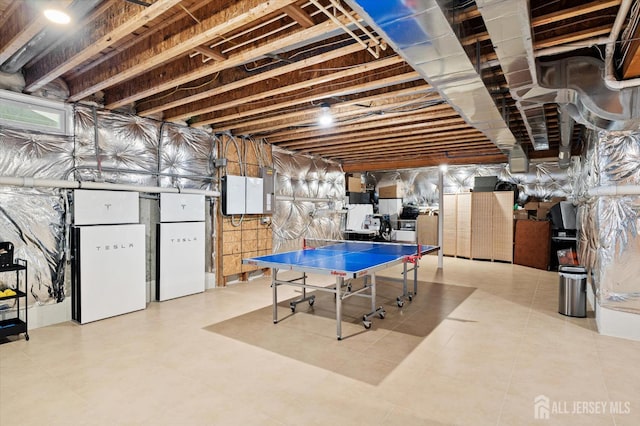 9 Bouvier Ln, South Brunswick, NJ 08816 - unfinished basement with electric panel and freestanding refrigerator
