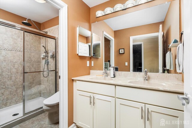 9 Bouvier Ln, South Brunswick, NJ 08816 - full bathroom featuring a stall shower, double vanity, toilet, and tile patterned flooring