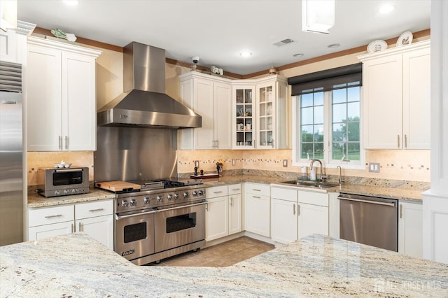 9 Bouvier Ln, South Brunswick, NJ 08816 - kitchen featuring wall chimney exhaust hood, high quality appliances, a sink, decorative backsplash, and light stone countertops
