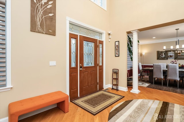 9 Bouvier Ln, South Brunswick, NJ 08816 - entrance foyer featuring decorative columns, wood finished floors, baseboards, ornamental molding, and a chandelier