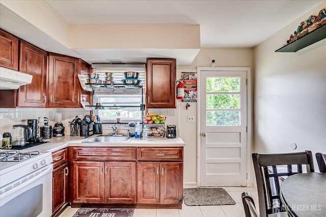 84 Kossuth St, Piscataway, NJ 08854 - kitchen featuring gas range gas stove, healthy amount of natural light, tasteful backsplash, and under cabinet range hood