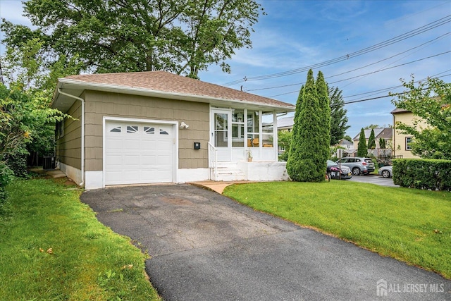 84 Kossuth St, Piscataway, NJ 08854 - ranch-style home with a front yard, asphalt driveway, roof with shingles, and an attached garage