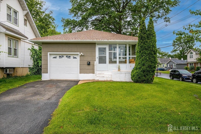 84 Kossuth St, Piscataway, NJ 08854 - view of front facade with a front yard, driveway, a sunroom, and a garage