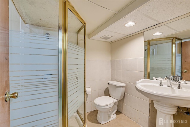 84 Kossuth St, Piscataway, NJ 08854 - bathroom with a stall shower, tile patterned floors, tile walls, recessed lighting, and wainscoting
