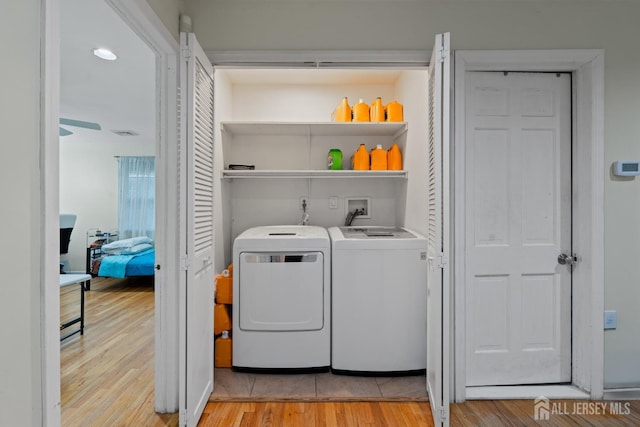 910 Curtis Pl, North Brunswick, NJ 08902 - laundry room with washer and clothes dryer and light wood-style floors