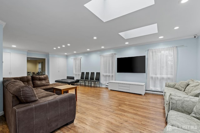 910 Curtis Pl, North Brunswick, NJ 08902 - living room featuring a skylight, light wood-style floors, a baseboard radiator, crown molding, and recessed lighting