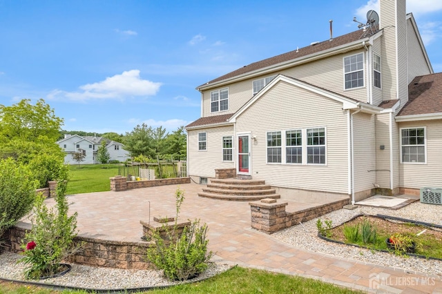 6 Garretson Dr, Franklin, NJ 08823 - back of house with a patio and a chimney
