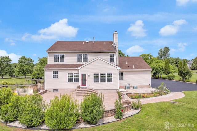 6 Garretson Dr, Franklin, NJ 08823 - back of property with a chimney and a patio area
