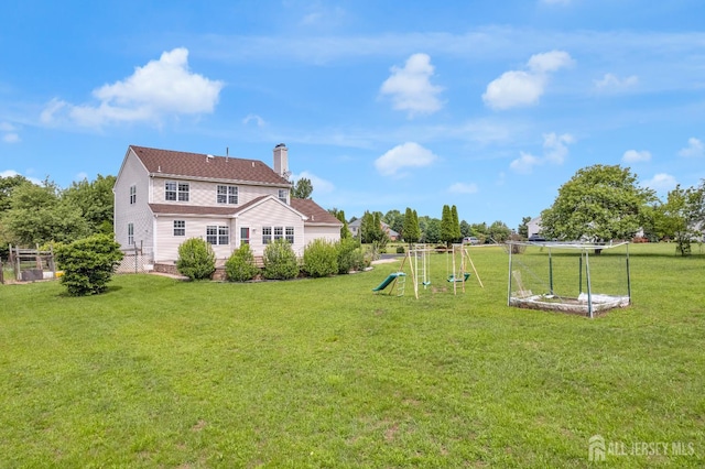 6 Garretson Dr, Franklin, NJ 08823 - back of property featuring a playground and a chimney
