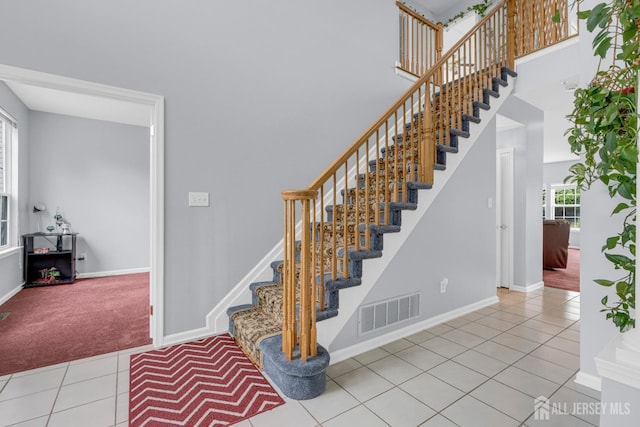 6 Garretson Dr, Franklin, NJ 08823 - stairs featuring healthy amount of natural light, tile patterned floors, baseboards, carpet, and a towering ceiling