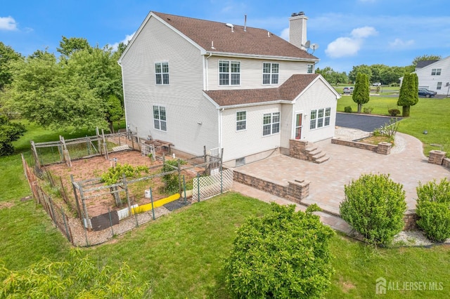 6 Garretson Dr, Franklin, NJ 08823 - back of house with a garden, a patio area, a lawn, a chimney, and a shingled roof