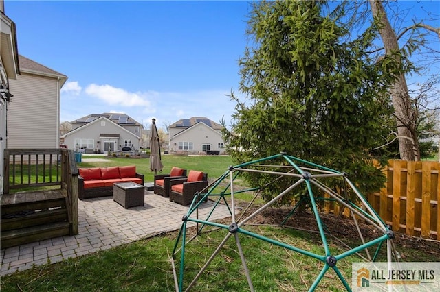 view of playground with fence, an outdoor hangout area, a patio area, a lawn, and a residential view
