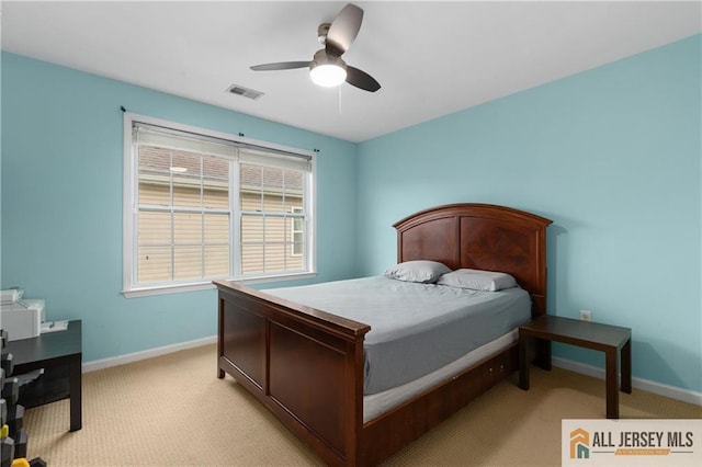 bedroom with visible vents, baseboards, and light carpet